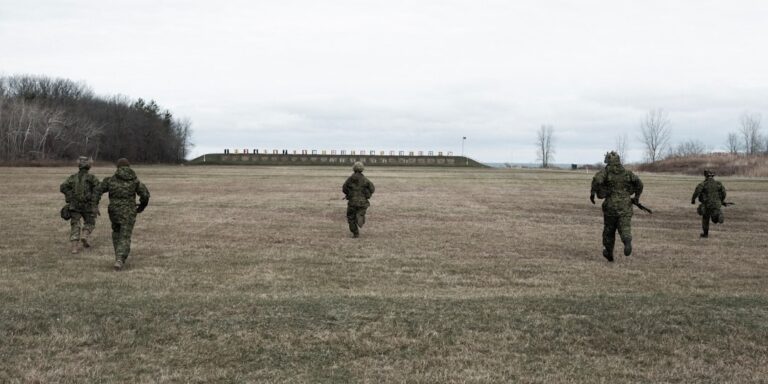 Soldier walking across a training field representing Army physical fitness standards